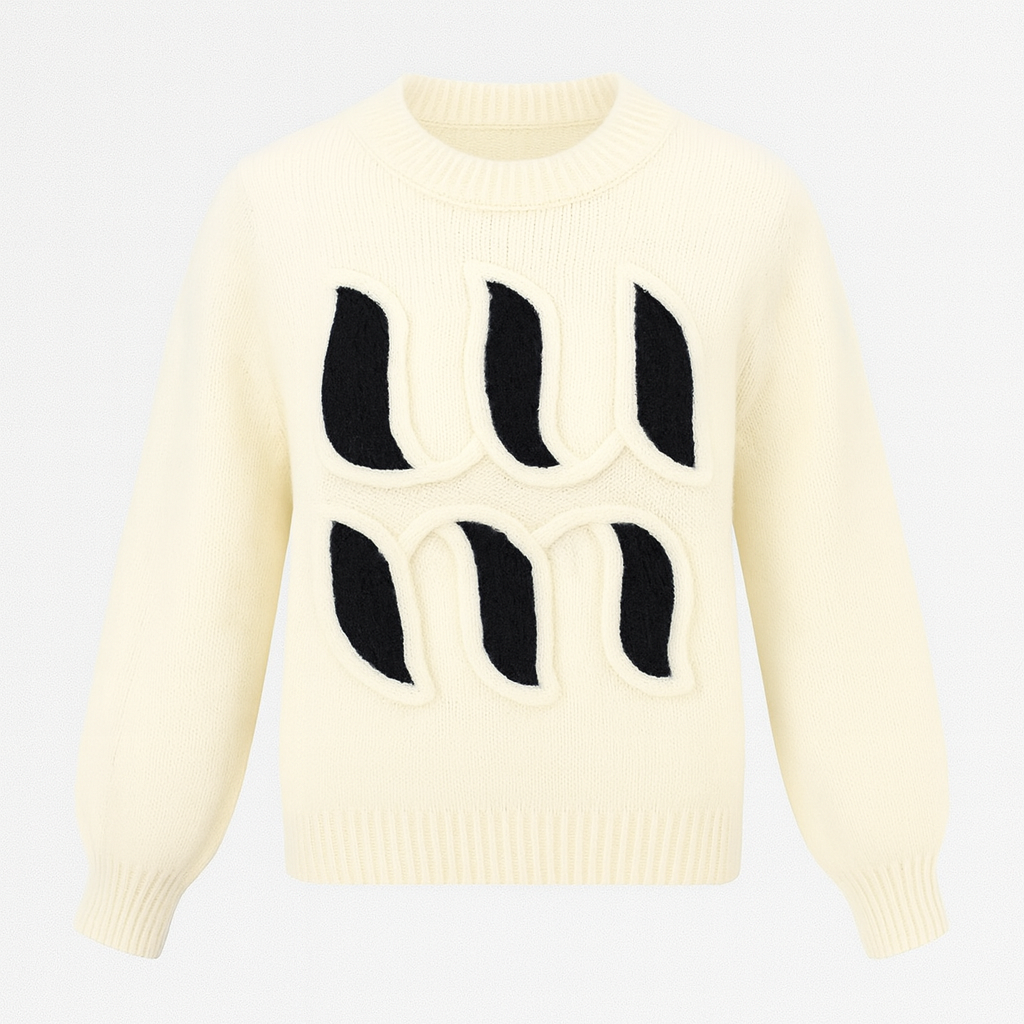 Cream knit sweater with bold black abstract appliqué design on the front and long sleeves.