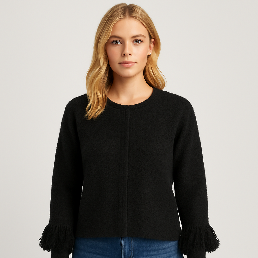 Black knit cardigan with long sleeves and fringe detailing on the cuffs.